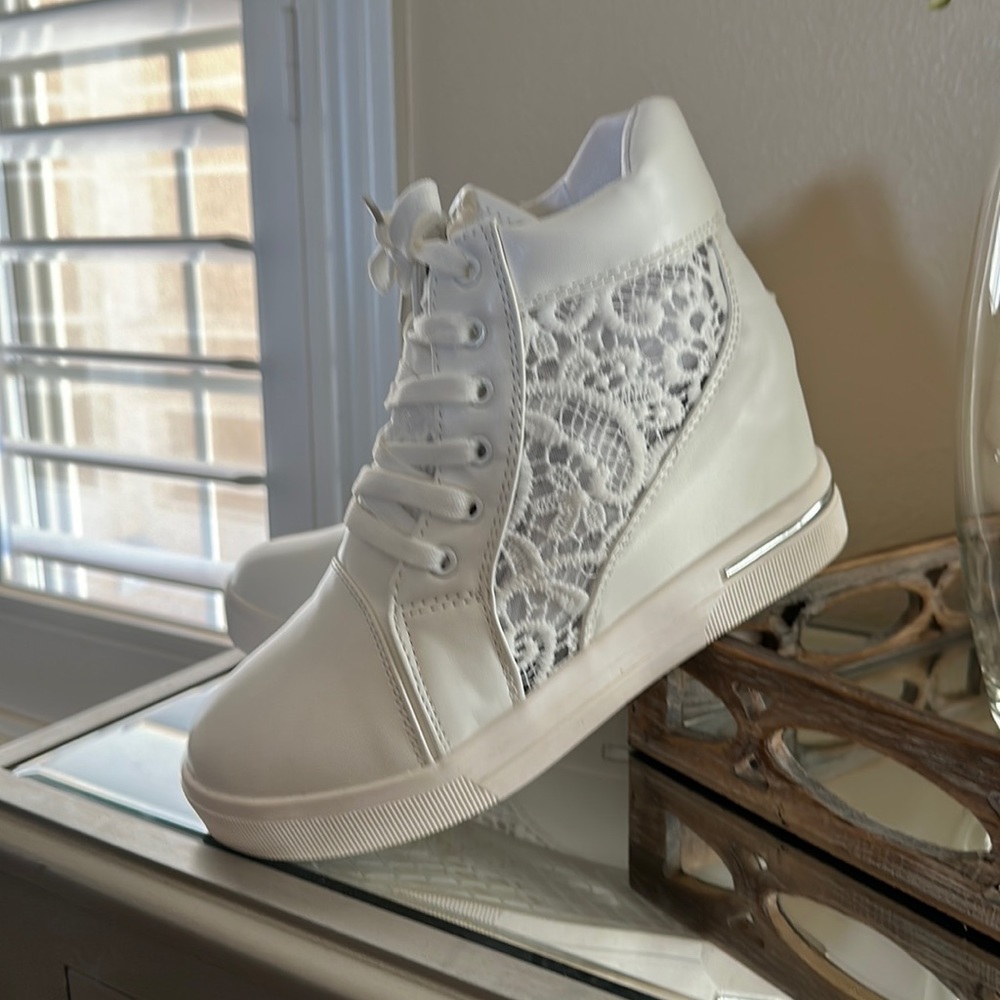 Cute platform tennis shoes with lace insert and metallic accent. Never worn